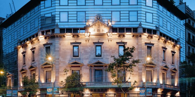 Illuminated historic façade of Claris Hotel & Spa in Barcelona