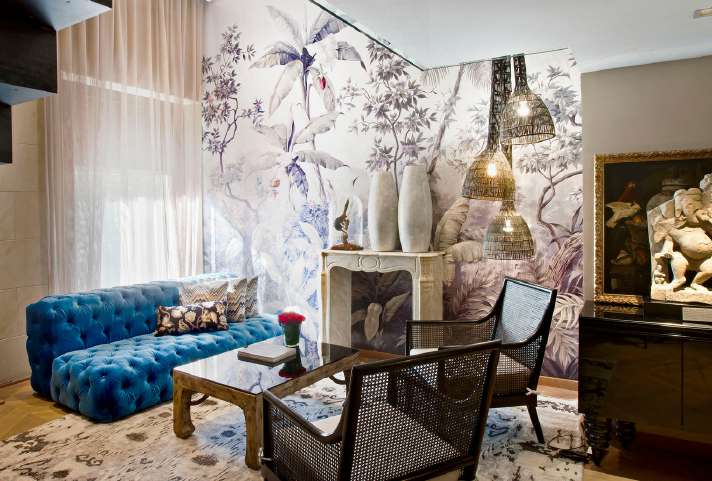 Claris hotel lounge with blue sofa, art, and contemporary furnishings