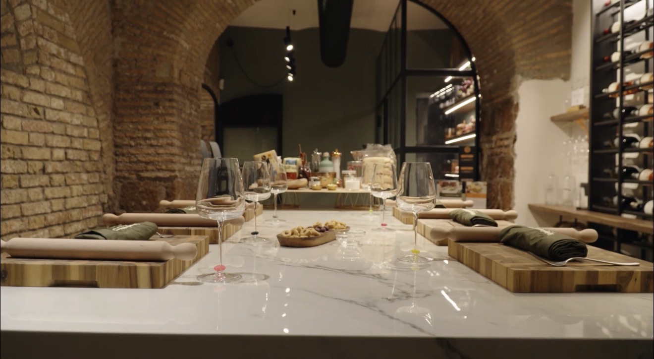 Private cooking class kitchen with brick arches and set marble counters