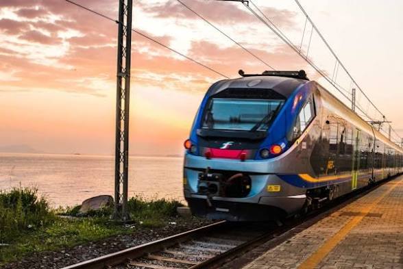 Regional train along the Italian coast at sunrise